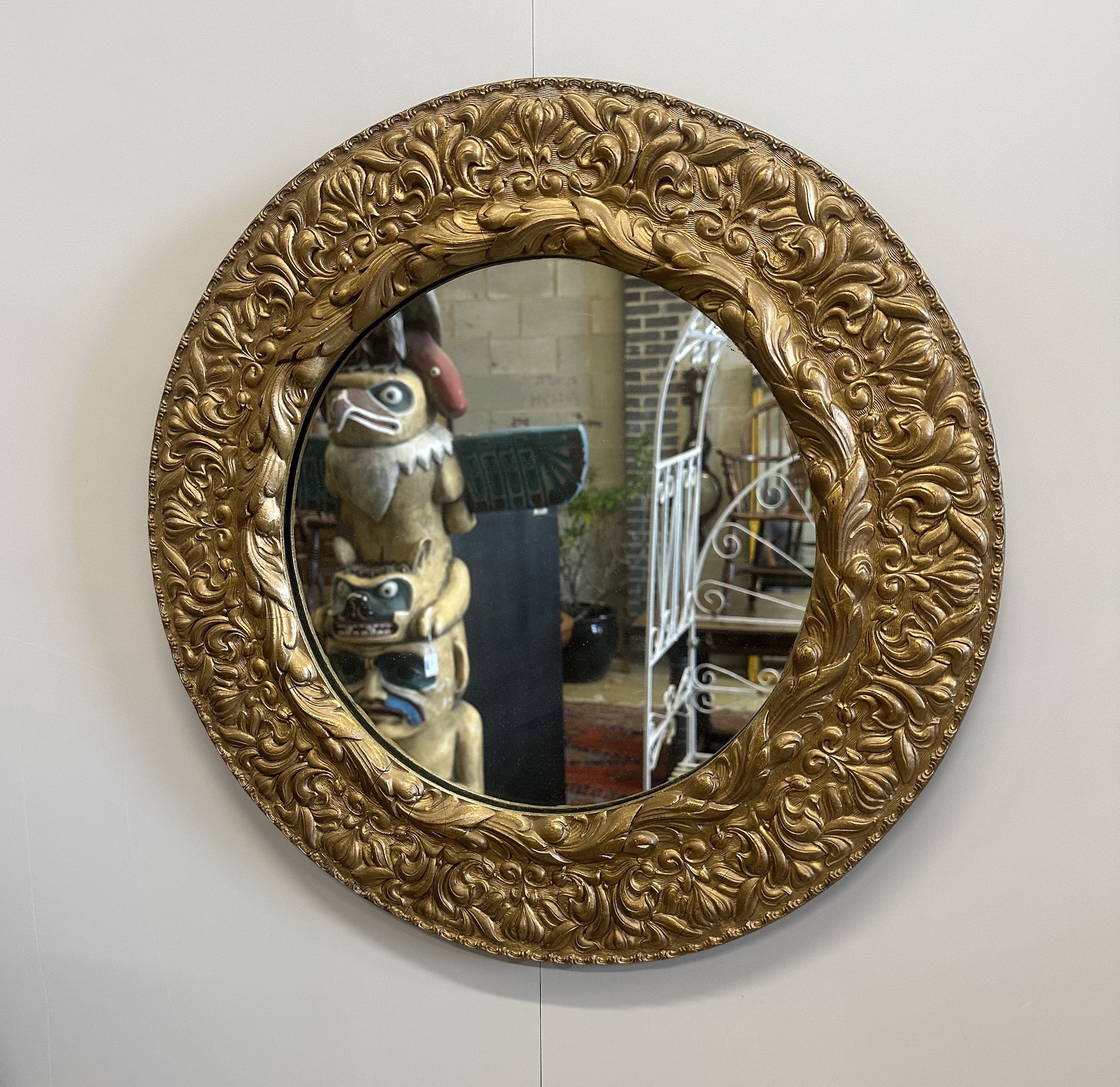 A circular gilt composition wall mirror, diameter 53cm